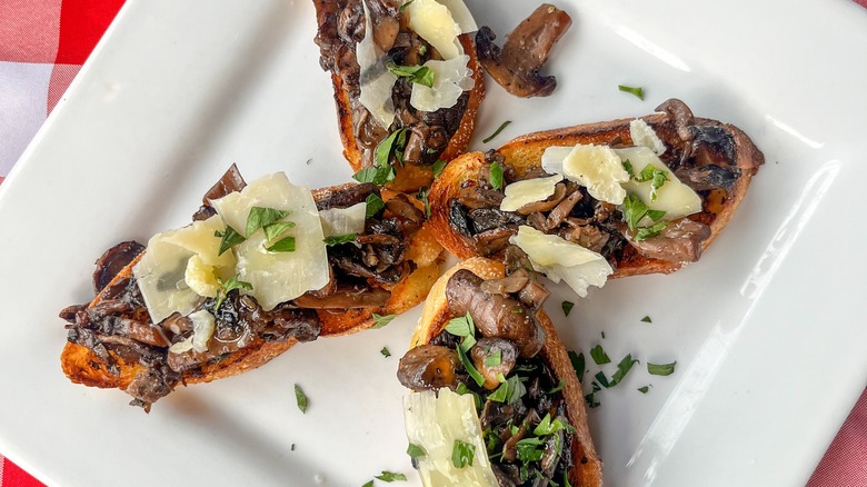 mushroom crostini on a white plate