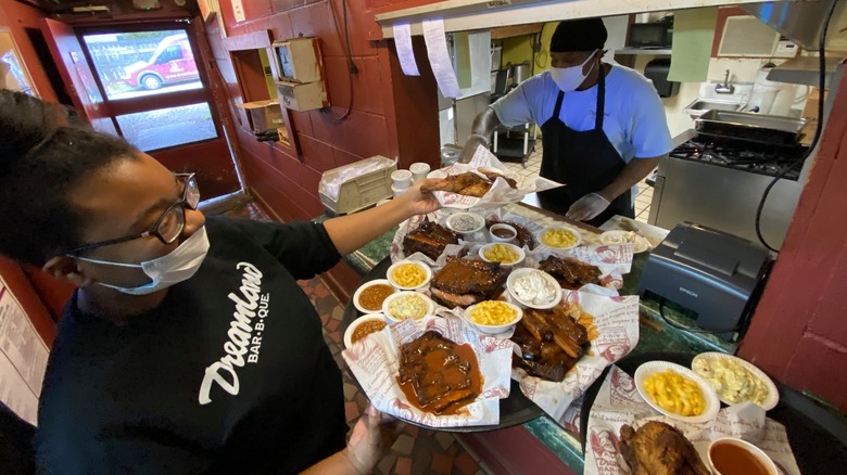 restaurant employee holding food