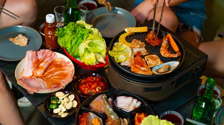 Korean barbecue with beer bottles