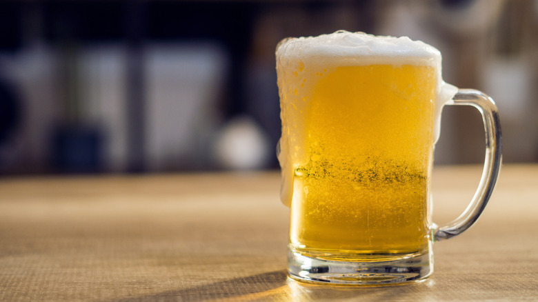 An ice-cold glass of beer covered with water drops