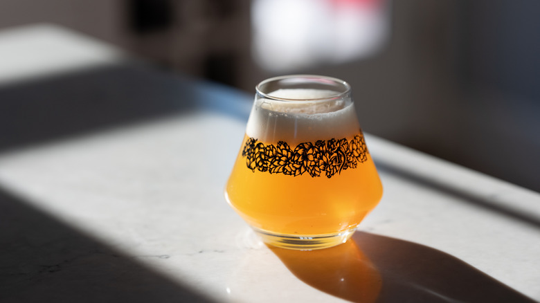 Hazy New England-style IPA in a glass with intricate hop design