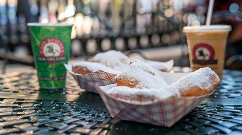 Paper baskets of beignets on table