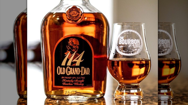 A bottle and glass of Old Grand-Dad 114 bourbon