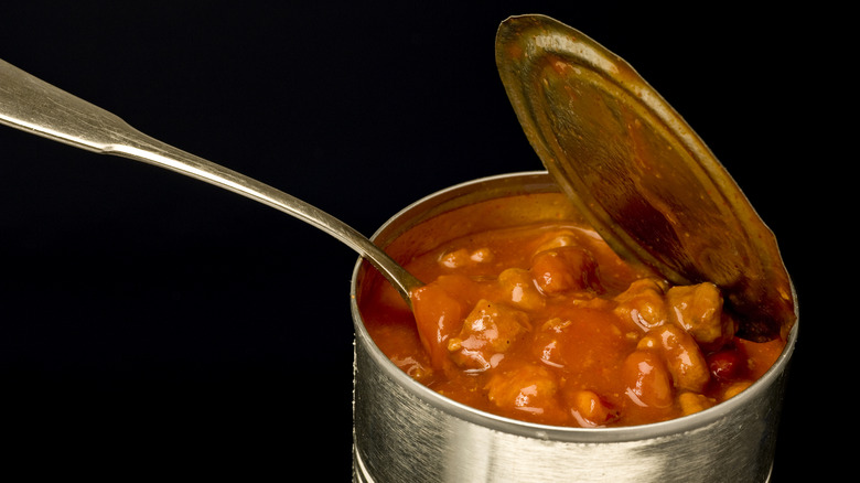 can of beans open on black background