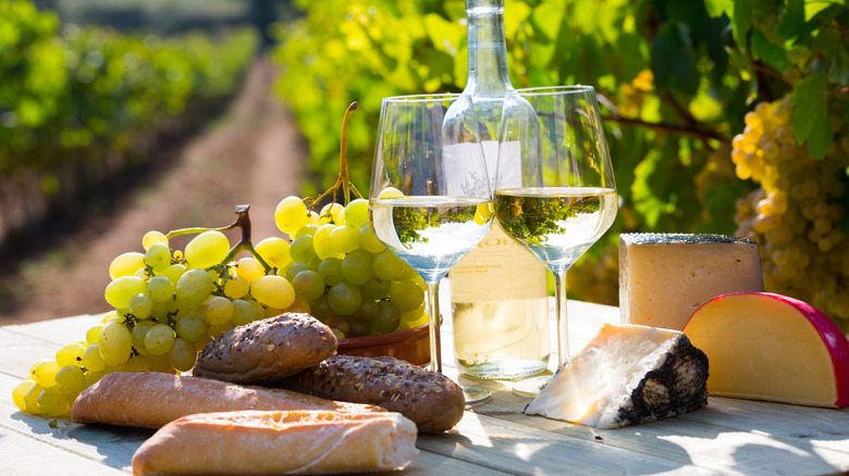 Cheese board with bread and white wine