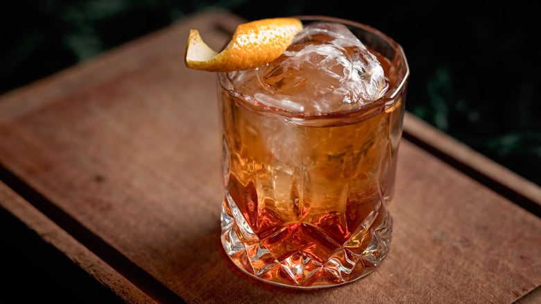 Old fashioned cocktail on wooden table