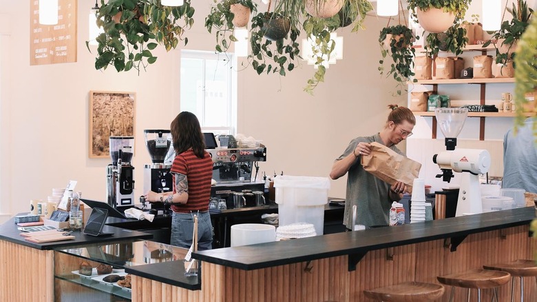 Baristas pouring coffee in a cafe