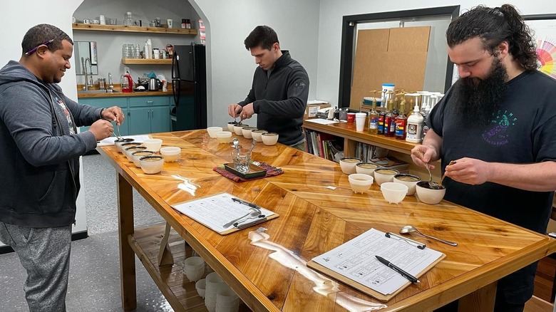 Baristas experimenting with coffee beans in the coffee lab