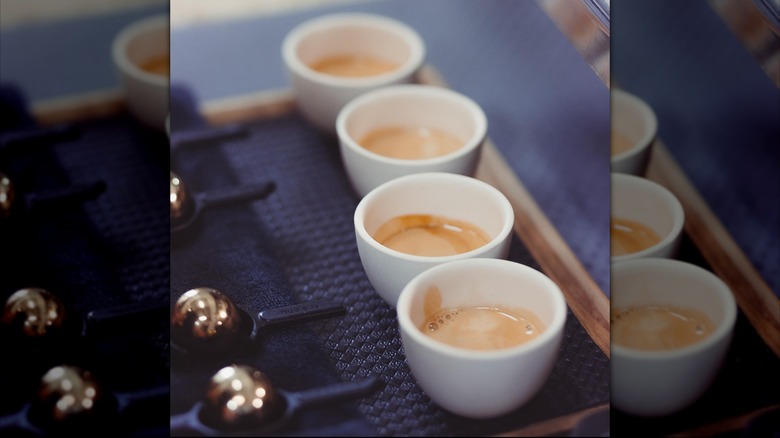 Coffee cups lined up on blue background