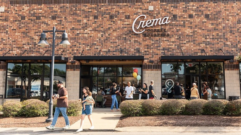 Customers walking in and out of Crema Coffee Roasters