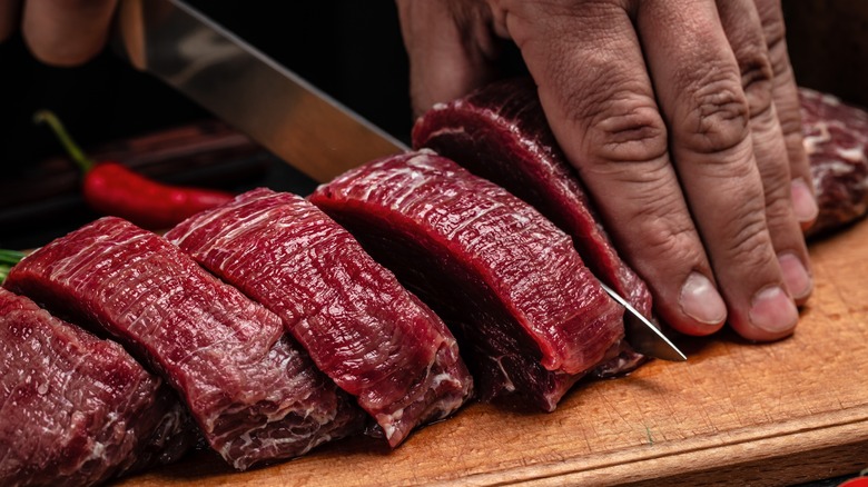 steak medallions being sliced