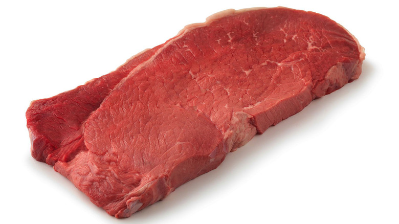 Raw top round steak.