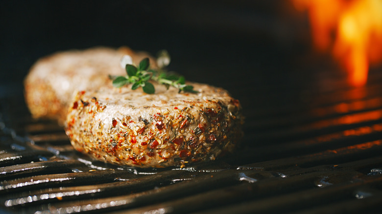 Seasoned lamb burgers on grill