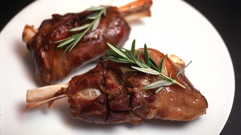 cooked lamb shanks garnished with rosemary