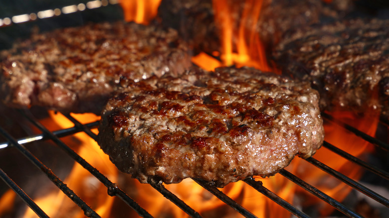 Flames cooking burgers