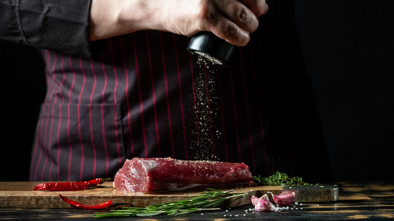 Chef marinading steak