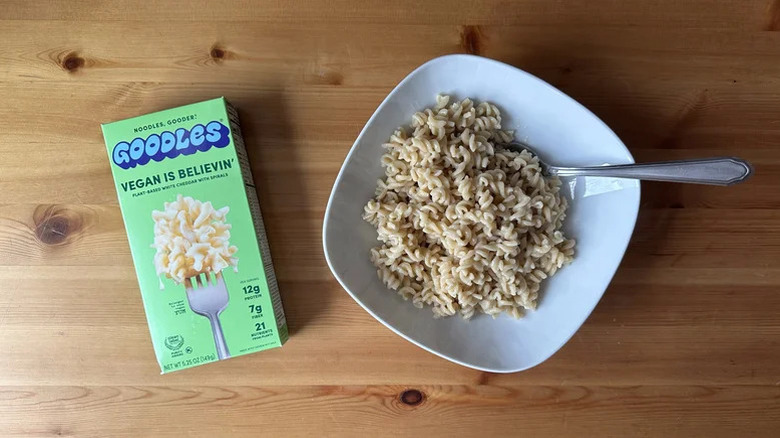 A box of Goodles vegan mac and cheese next to a bowl of mac and cheese