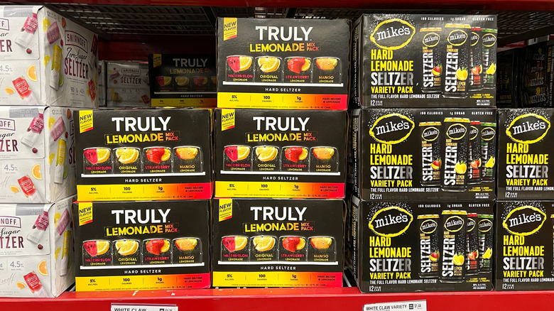 A few different brands of hard lemonades on the shelf at the store in boxes