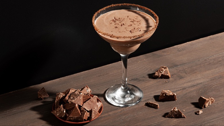 A chocolate martini on a table with chocolate