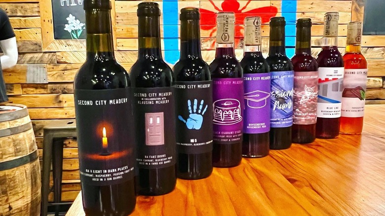 A row of Second City Meadery bottles.