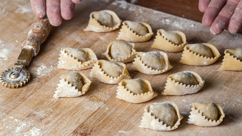 uncooked ravioli on cutting board