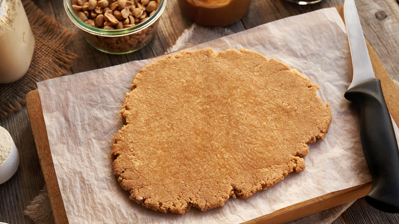 peanut butter dessert dough rolled out on parchment paper