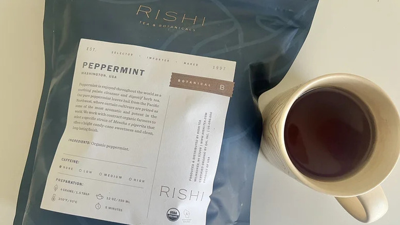 Bag of Rishi brand tea and a cup of brewed tea next to it