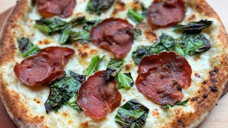 Pizza with sausage and greens