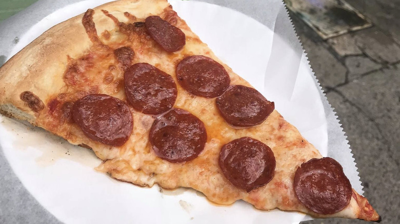 Pepperoni slice on paper plate