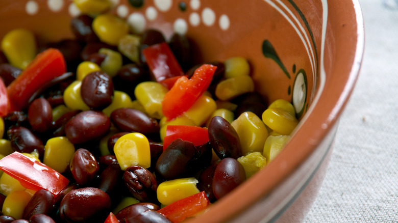 Colorful peppers, corn and bean succotash in a bowl