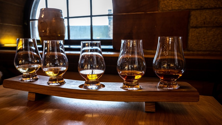 Flight board of bourbon tasting glasses