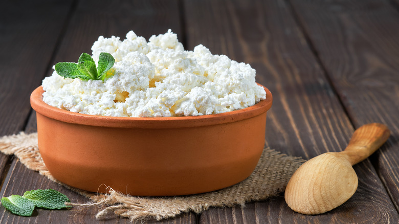 Garnished cottage cheese in a clay bowl