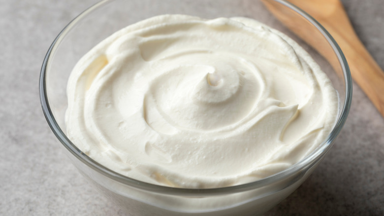 A glass bowl filled with Crème Fraîche 