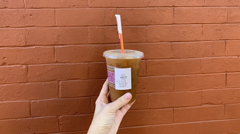 Dunkin hazelnut iced coffee red brick wall