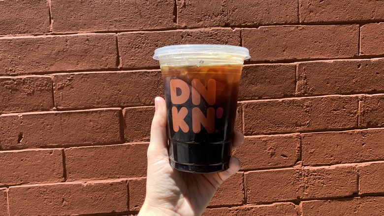 Dunkin iced americano brick wall