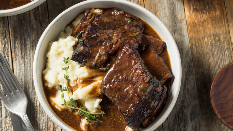 Beef short ribs in sauce over mashed potatoes