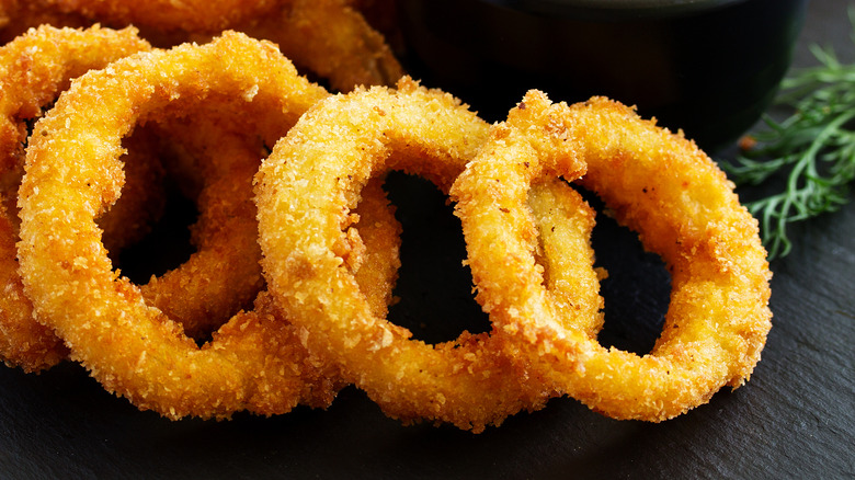 Fried onions close up on dark surface