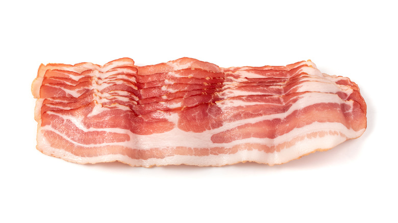 raw bacon on white background