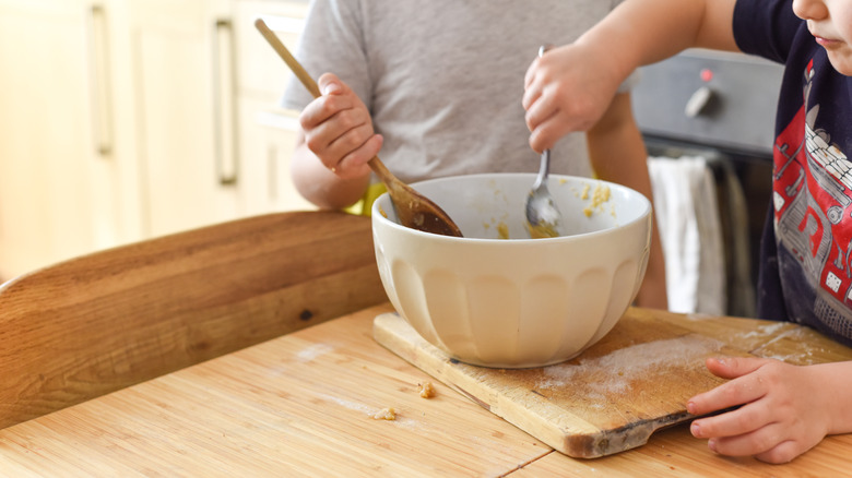 boys mixing dough in a bowl