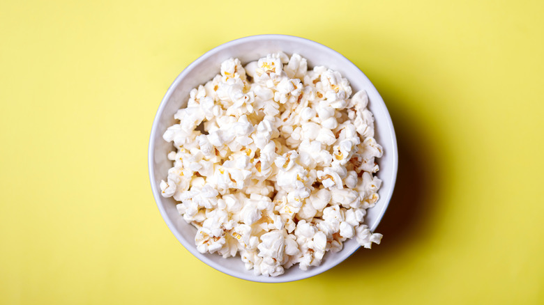 bowl of popcorn yellow background