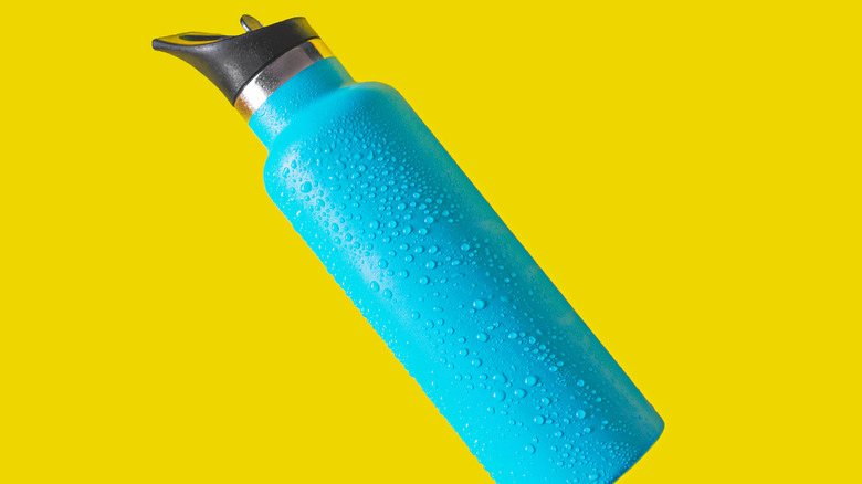 Blue water bottle on yellow background