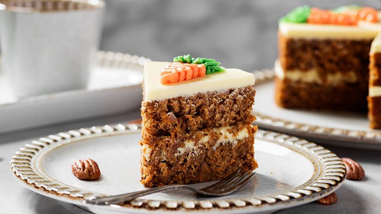 Frosted carrot cake on white plate 