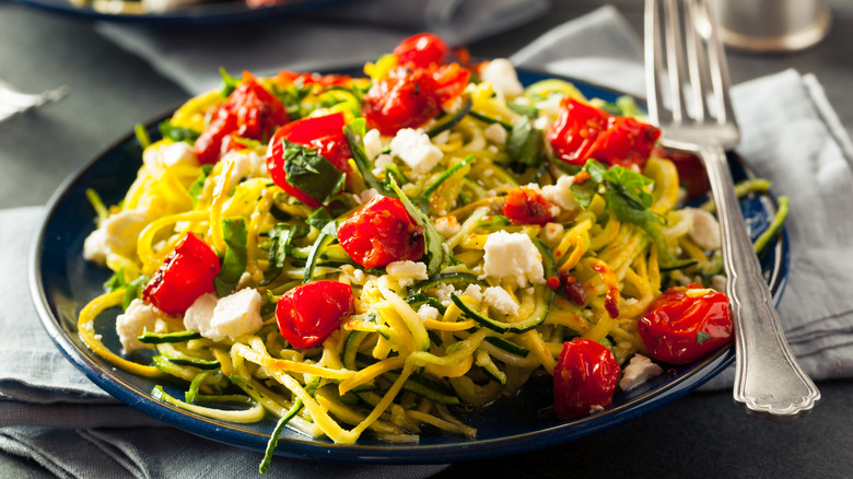 Zucchini noodles tomatoes and feta plate 