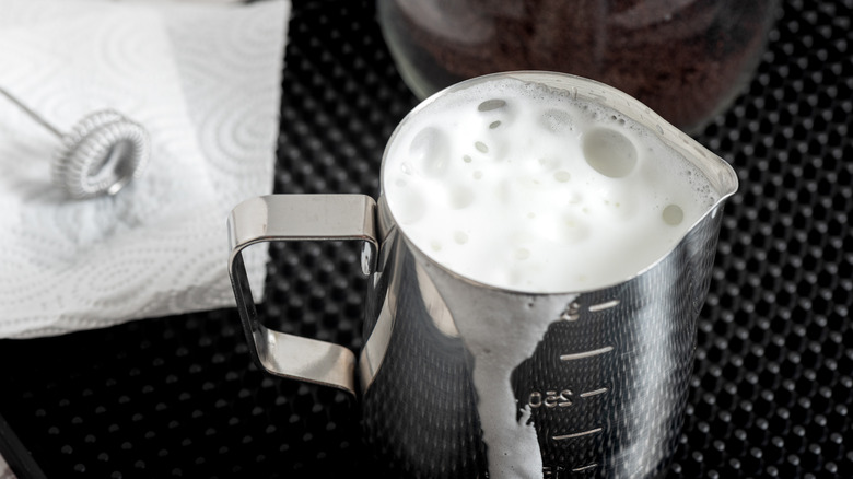 Steel container with frothed milk