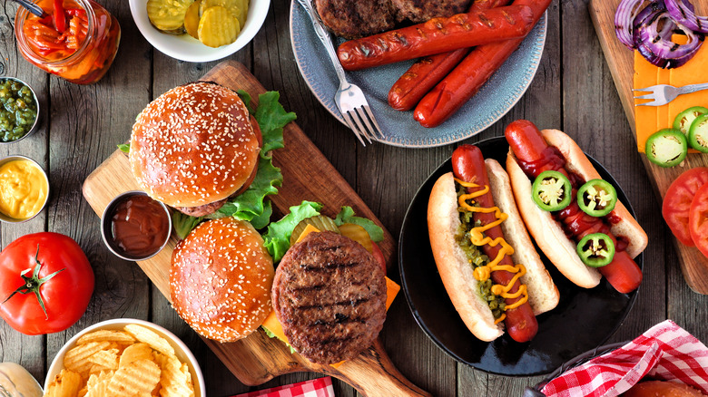 BBQ table spread with hamburgers and hot dogs