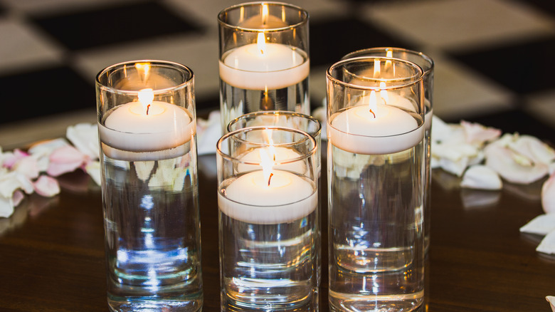 floating votive candles in glass containers 