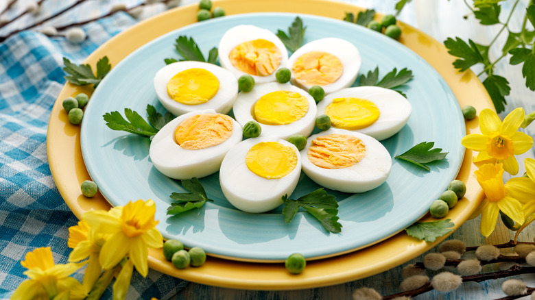 Plate of hard-cooked eggs with parsley and peas 