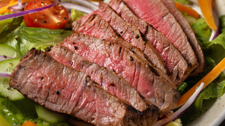 Medium rare steak on a salad