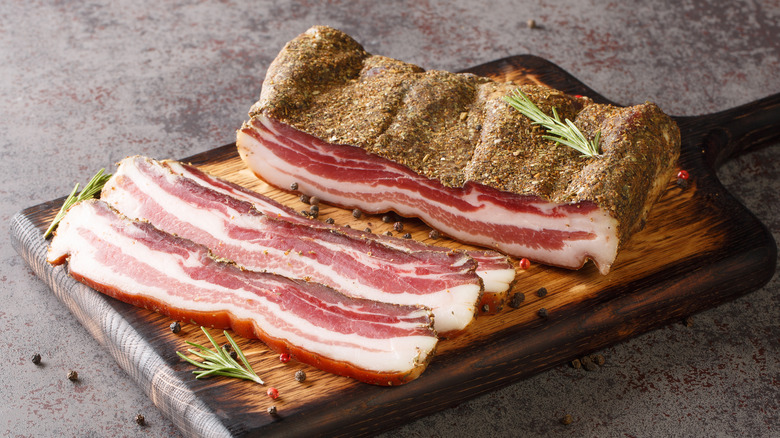 Seasoned slab bacon on a cutting board