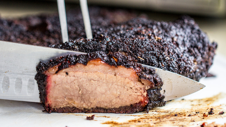 close up shot of slicing brisket with a knife